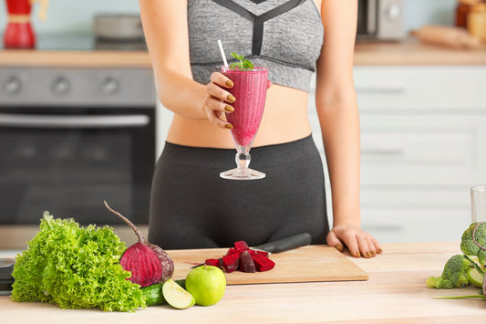 Woman holding glass of beetroot juice