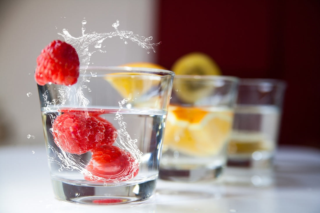 Fresh glass of water with fruits
